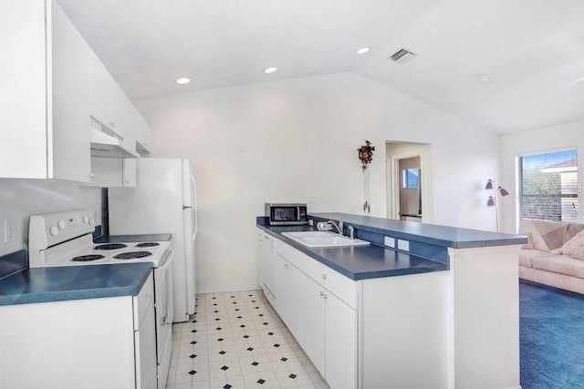 kitchen with lofted ceiling, sink, white appliances, white cabinets, and wall chimney exhaust hood