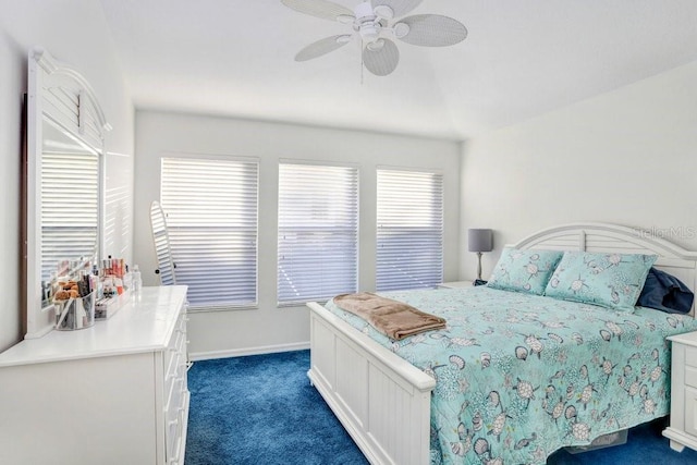 bedroom with ceiling fan and dark carpet