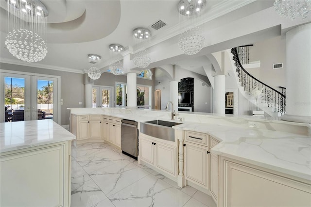 kitchen featuring french doors, light stone counters, crown molding, pendant lighting, and cream cabinetry