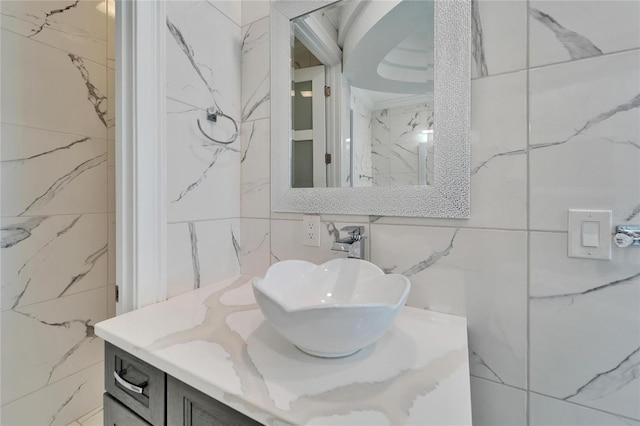 bathroom with vanity and tile walls