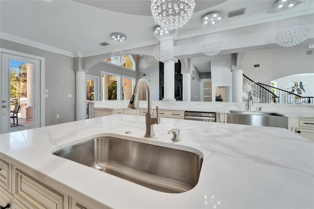 kitchen featuring crown molding, sink, light stone counters, and a chandelier