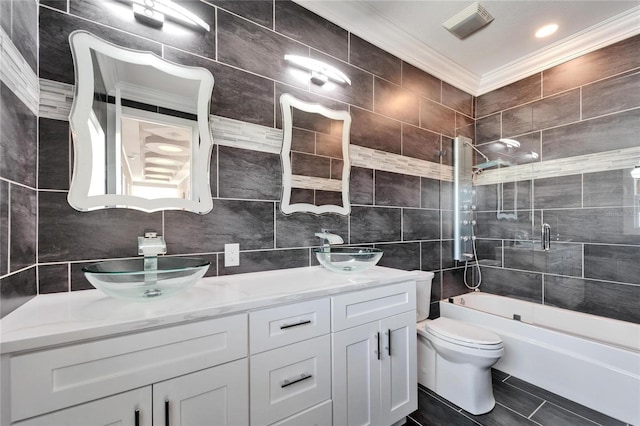 full bathroom with crown molding, vanity, shower / bath combination with glass door, and tile walls