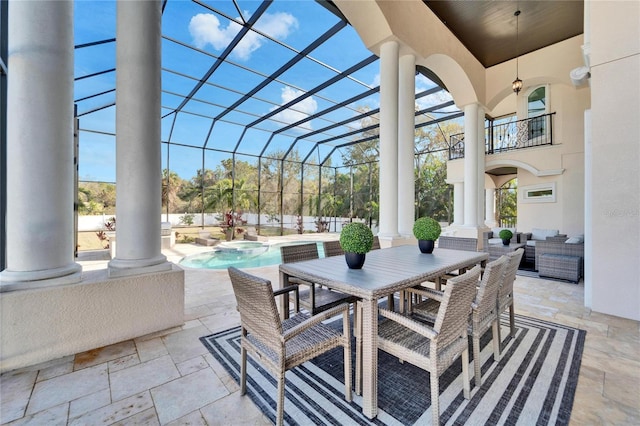 view of patio / terrace featuring a lanai, a balcony, an outdoor hangout area, and a pool with hot tub