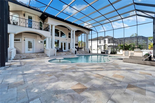 view of swimming pool featuring an in ground hot tub, a patio, and glass enclosure