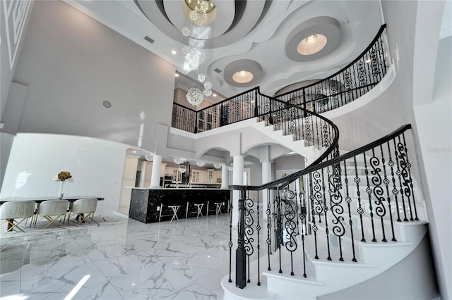 9401 93rd St, Seminole, FL 33777 - staircase with a high ceiling, marble tiled floors, and decorative columns