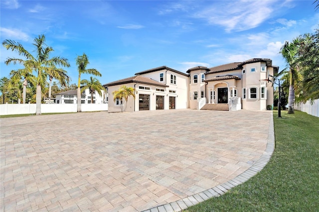 9401 93rd St, Seminole, FL 33777 - mediterranean / spanish-style home featuring decorative driveway, stucco siding, and a tiled roof