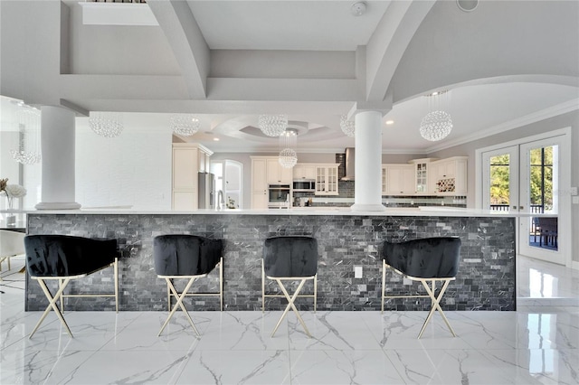 9401 93rd St, Seminole, FL 33777 - kitchen with ornamental molding, appliances with stainless steel finishes, a breakfast bar, light marble finish floors, and a chandelier