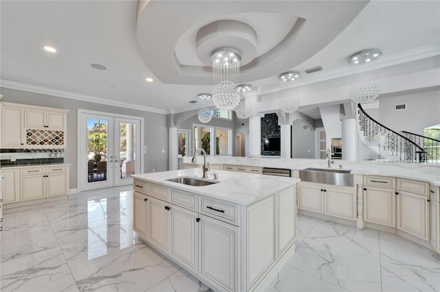 9401 93rd St, Seminole, FL 33777 - kitchen with cream cabinets, a sink, light marble finish flooring, recessed lighting, and crown molding