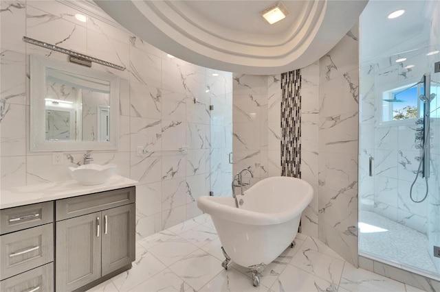 9401 93rd St, Seminole, FL 33777 - bathroom featuring tile walls, a marble finish shower, a freestanding tub, vanity, and marble tiled floors