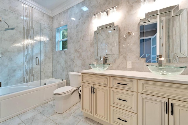 9401 93rd St, Seminole, FL 33777 - full bath featuring ornamental molding, toilet, tile walls, double vanity, and bath / shower combo with glass door