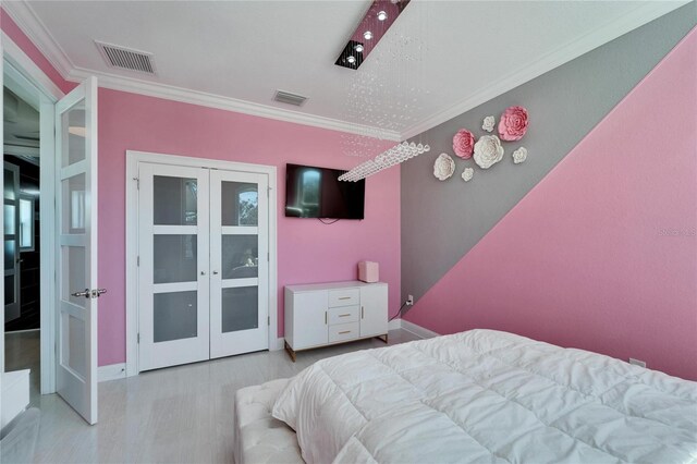 9401 93rd St, Seminole, FL 33777 - bedroom with french doors, crown molding, baseboards, and wood finished floors