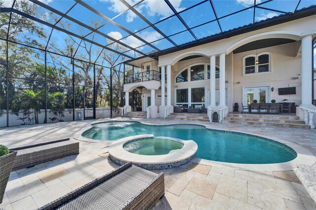 9401 93rd St, Seminole, FL 33777 - view of swimming pool with french doors, a patio, a pool with connected hot tub, and glass enclosure