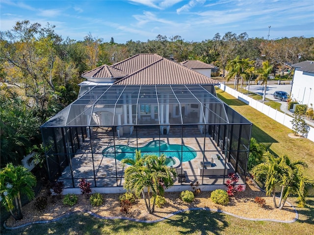 9401 93rd St, Seminole, FL 33777 - back of property featuring a patio area, a tiled roof, and glass enclosure