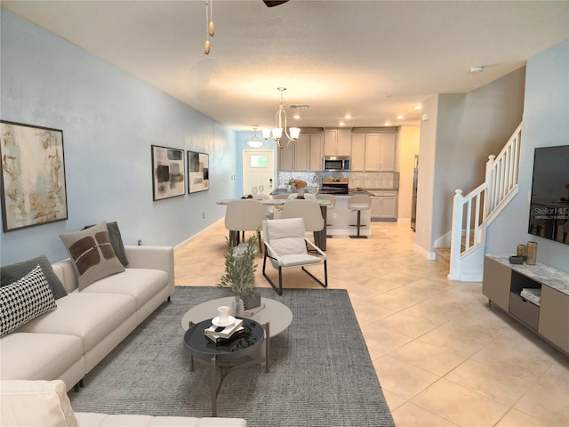 tiled living room featuring an inviting chandelier