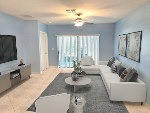 tiled living room featuring a textured ceiling and ceiling fan