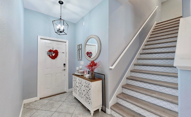 tiled entrance foyer featuring a chandelier