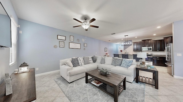 tiled living room featuring sink and ceiling fan