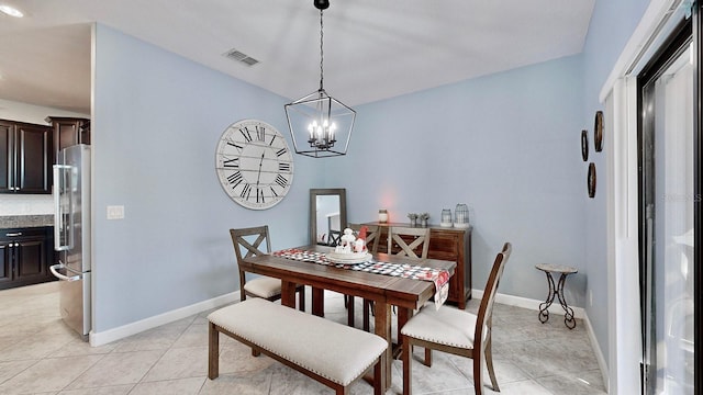 dining room with an inviting chandelier and light tile patterned flooring