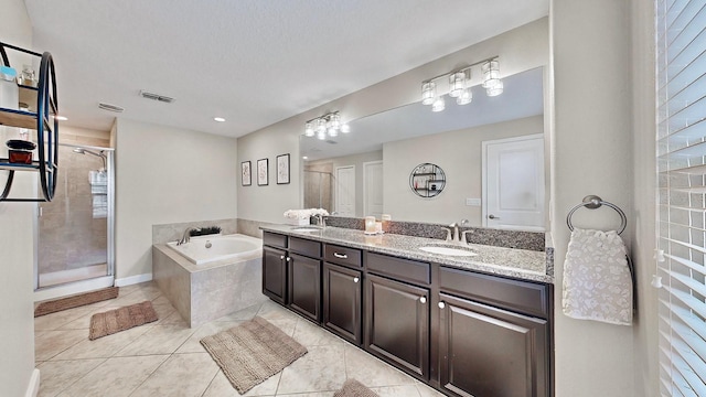 bathroom featuring vanity, shower with separate bathtub, and tile patterned flooring