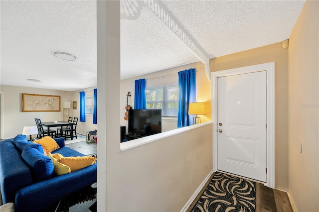 entrance foyer with hardwood / wood-style flooring and a textured ceiling