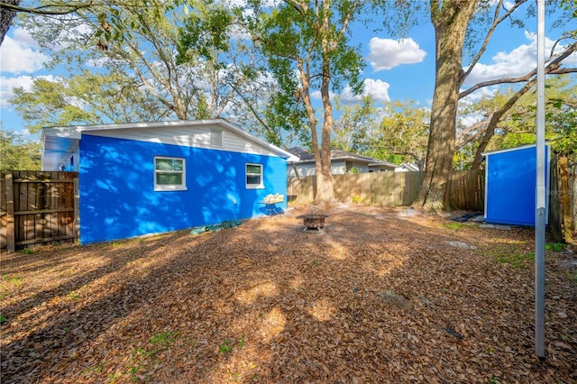 view of side of property featuring an outdoor fire pit