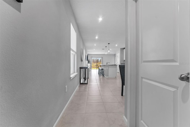 hall featuring light tile patterned floors