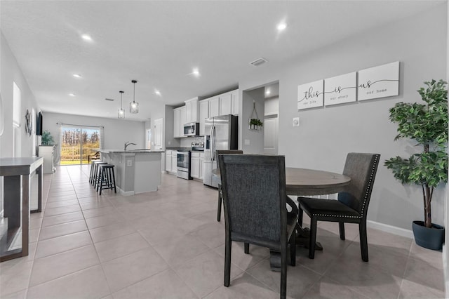 dining space featuring light tile patterned flooring