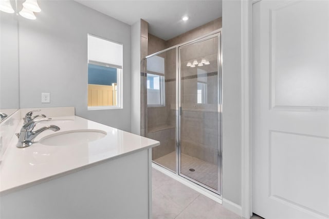 bathroom featuring an enclosed shower, vanity, and tile patterned flooring