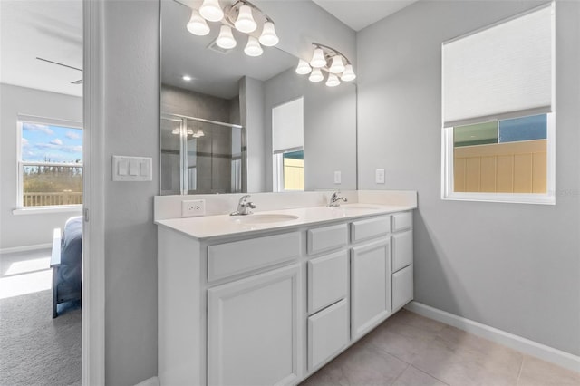 bathroom featuring vanity, tile patterned flooring, and a shower with door