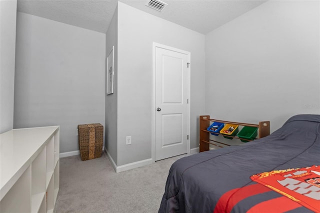 carpeted bedroom featuring a textured ceiling