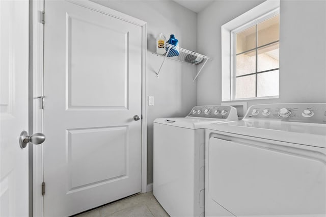 laundry room featuring washer and dryer and light tile patterned flooring