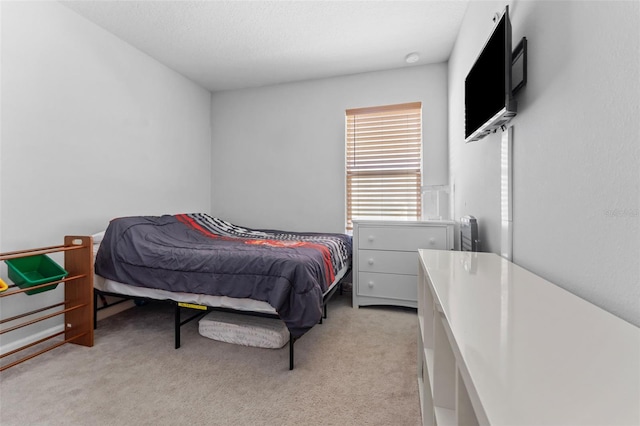 bedroom featuring light carpet