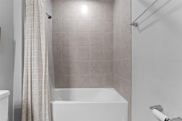 bathroom with shower / tub combo with curtain and toilet