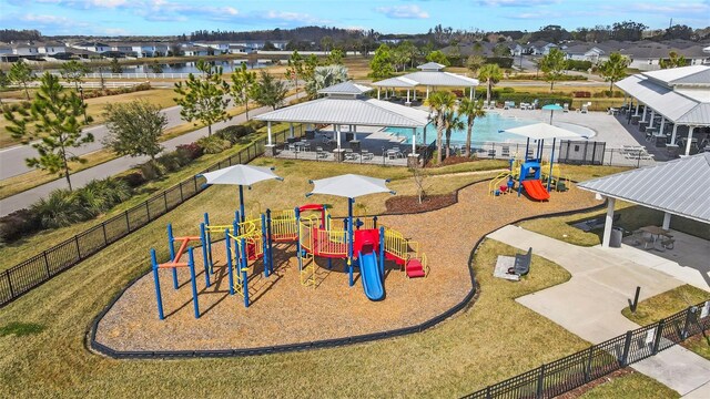 view of jungle gym featuring a gazebo, a lawn, and a water view