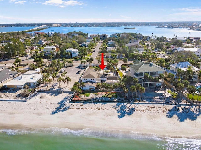 drone / aerial view featuring a water view and a view of the beach