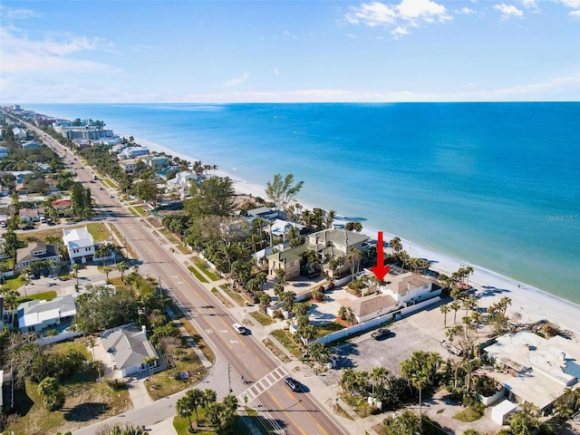 drone / aerial view featuring a water view and a view of the beach