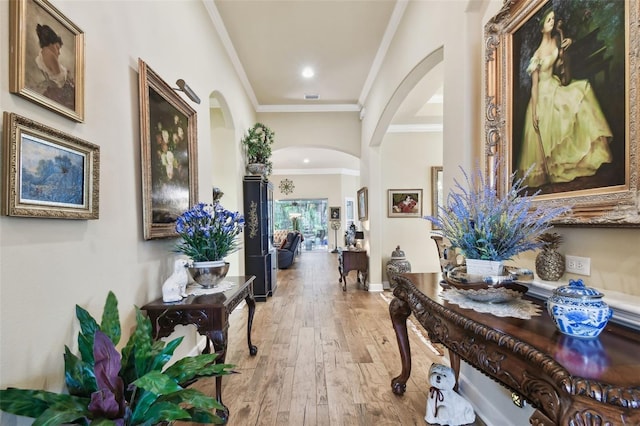 hall featuring ornamental molding and hardwood / wood-style floors