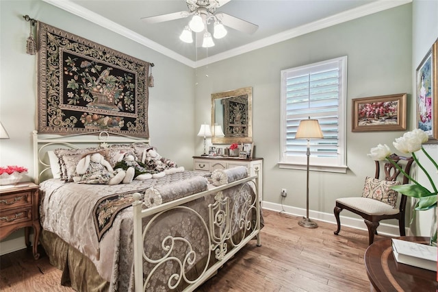 bedroom featuring ornamental molding, hardwood / wood-style floors, and ceiling fan