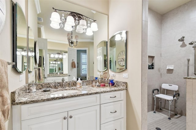 bathroom featuring vanity and tiled shower