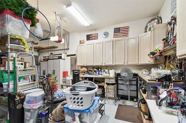 garage with a garage door opener and a workshop area