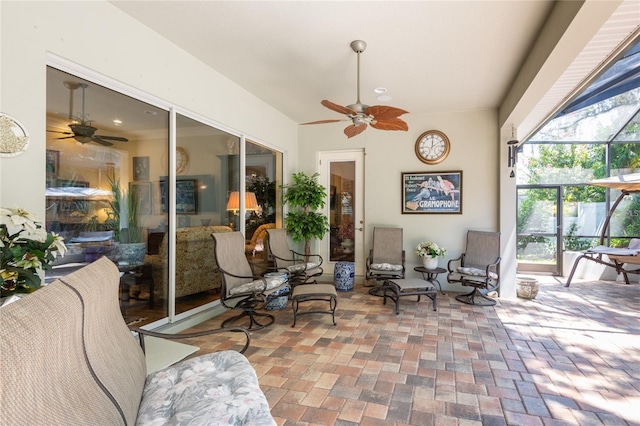 view of patio featuring ceiling fan and a lanai