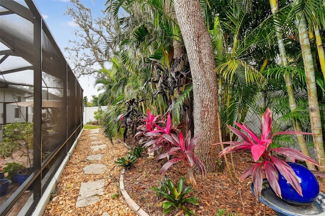 view of yard featuring glass enclosure