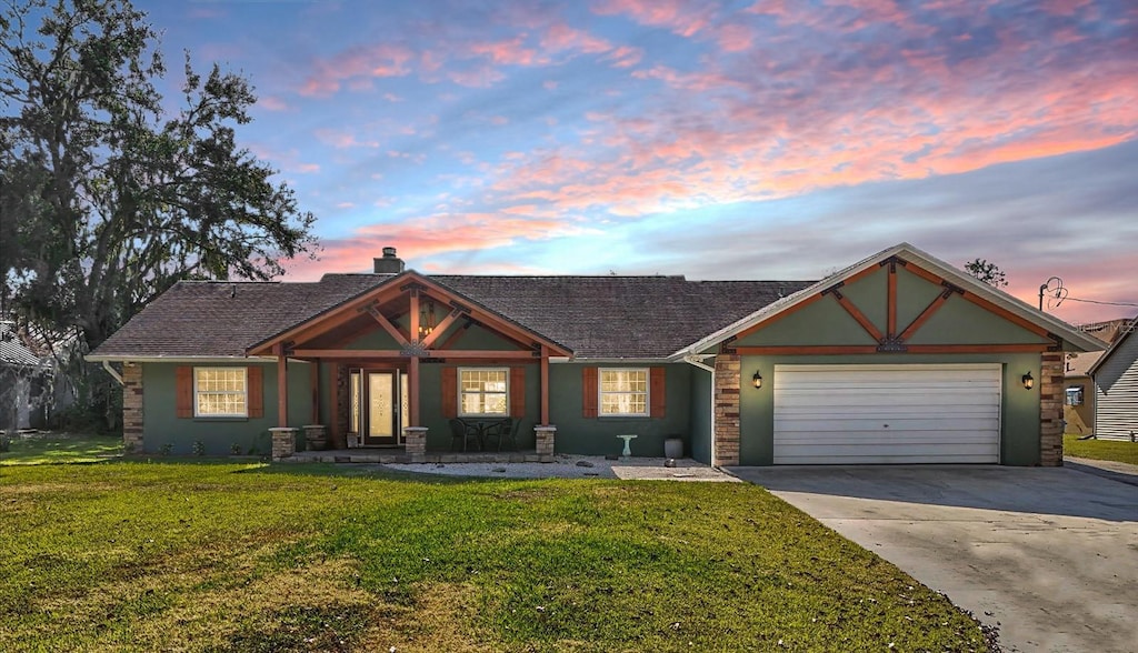 view of front of property featuring a garage and a yard