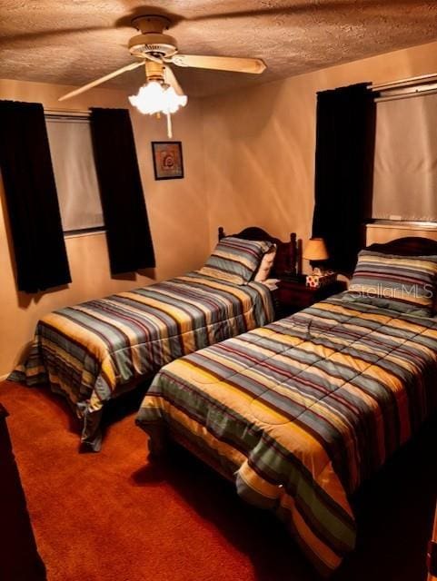 carpeted bedroom with a textured ceiling and ceiling fan