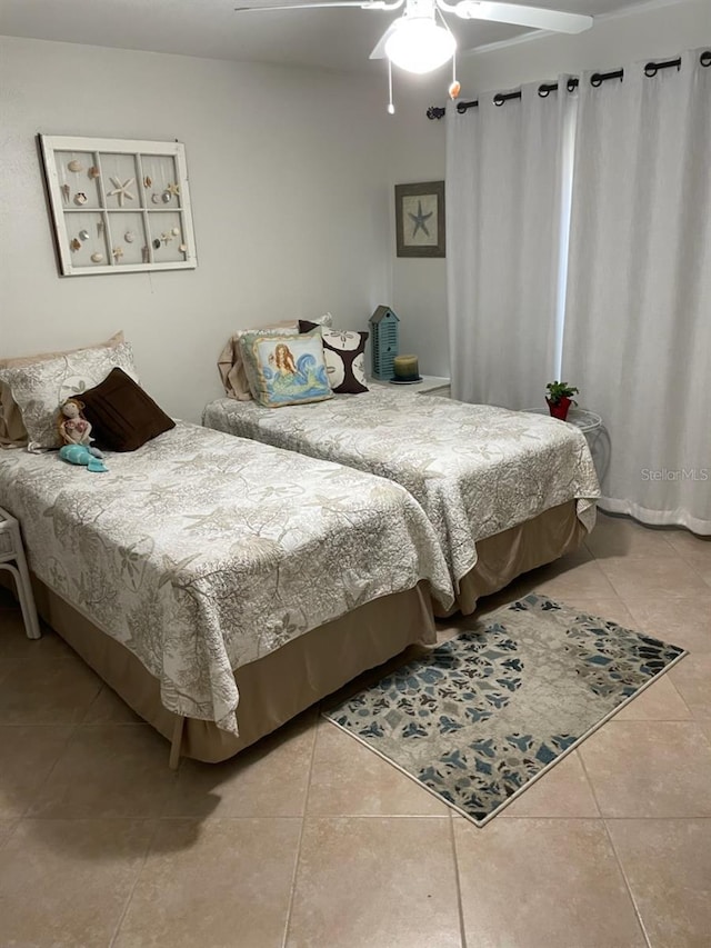 tiled bedroom with ceiling fan