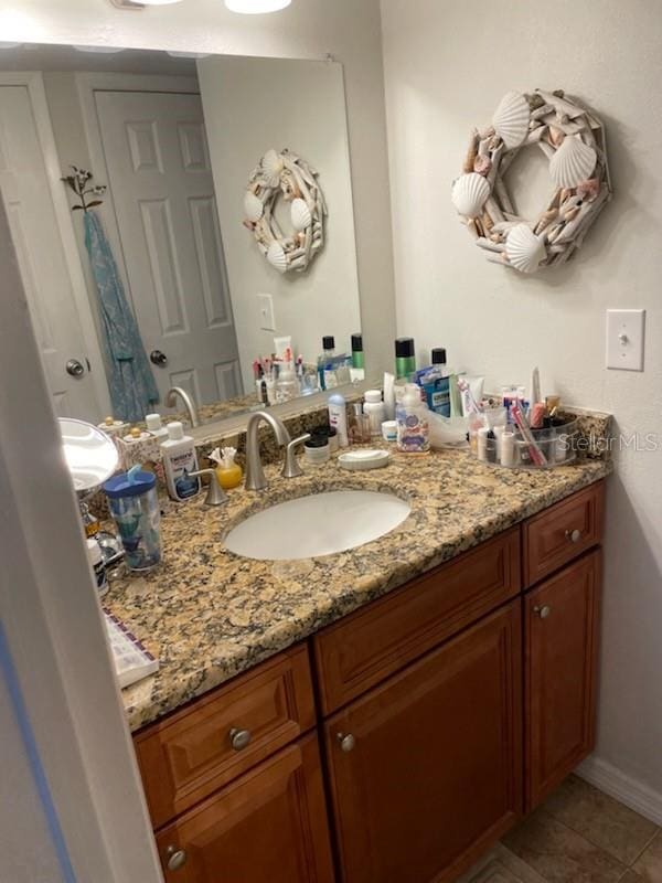 bathroom featuring tile patterned flooring and vanity