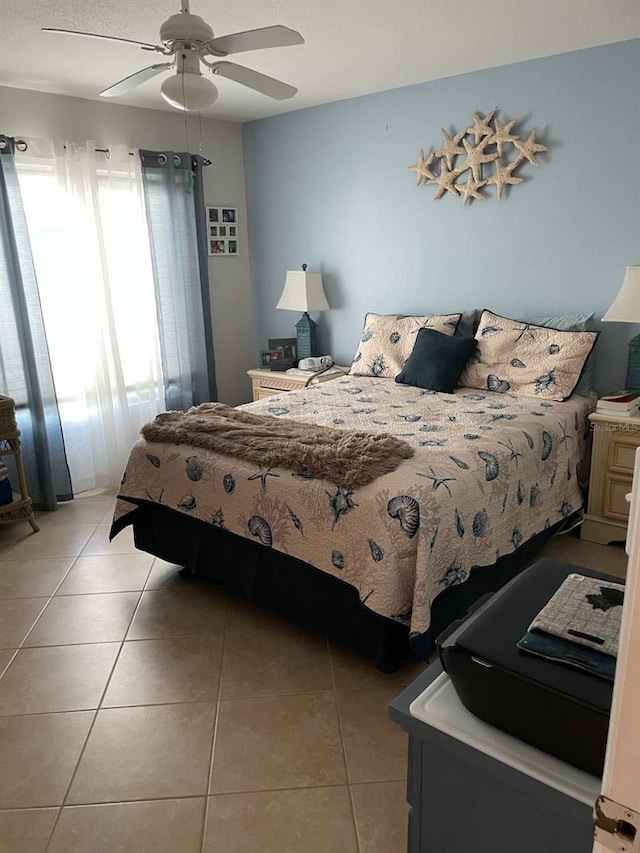 bedroom featuring light tile patterned flooring and ceiling fan