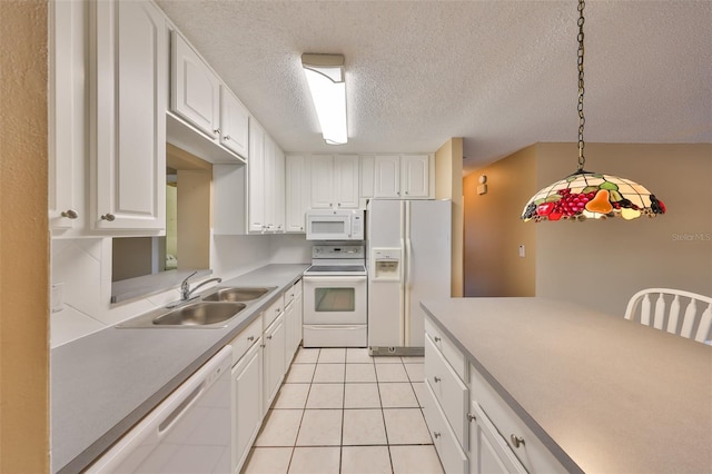 kitchen featuring hanging light fixtures, white appliances, sink, and white cabinets