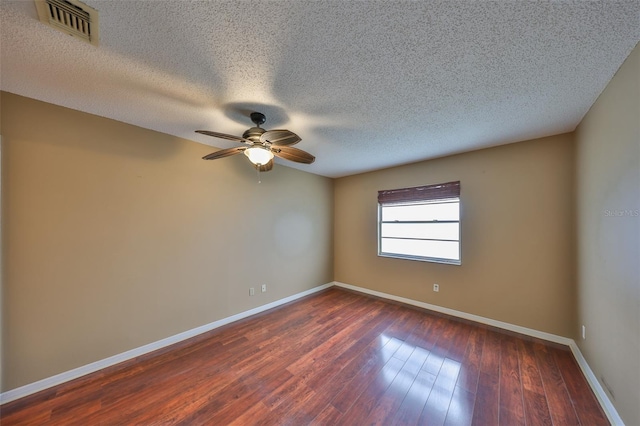 unfurnished room with a textured ceiling, dark hardwood / wood-style floors, and ceiling fan