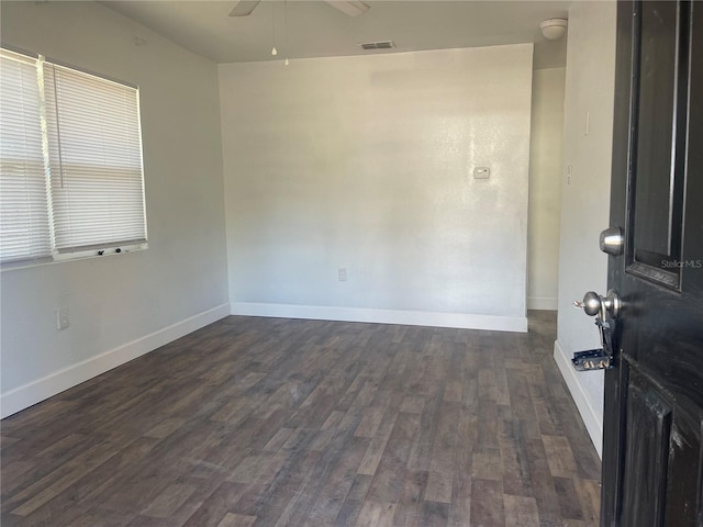 empty room with dark wood-type flooring and ceiling fan